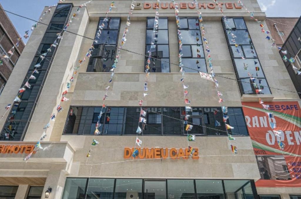 a building with christmas lights on the side of it at 드므호텔 in Changwon