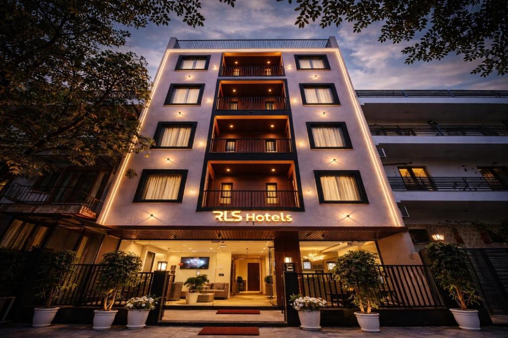 a large white building with a sign on it at RLS Hotels, Greater Noida Near Expo Centre & Mart in Greater Noida