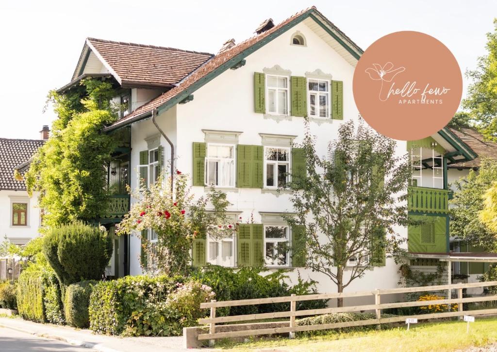 a white house with green shutters at Casa Verde Dornbirn by Hello Fewo Apartments in Dornbirn