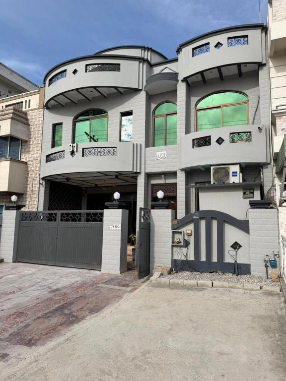 a large building with a gate in front of it at MadCrew GuestHouse in Islamabad