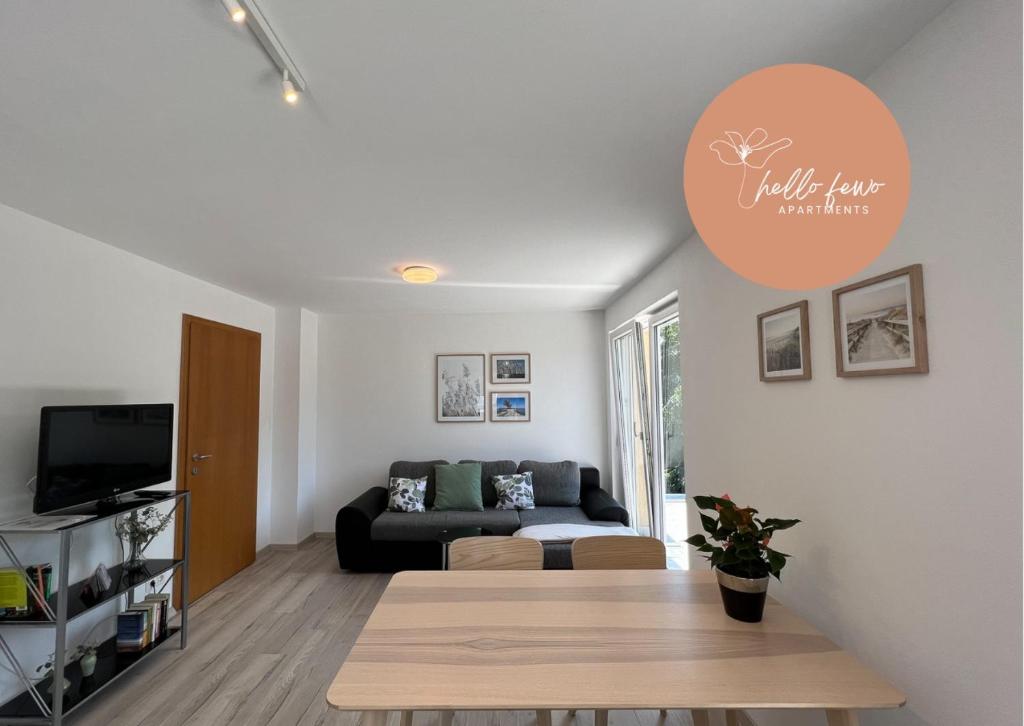 a living room with a couch and a table at Apartment Sunshine by Hello Fewo Apartments in Höchst