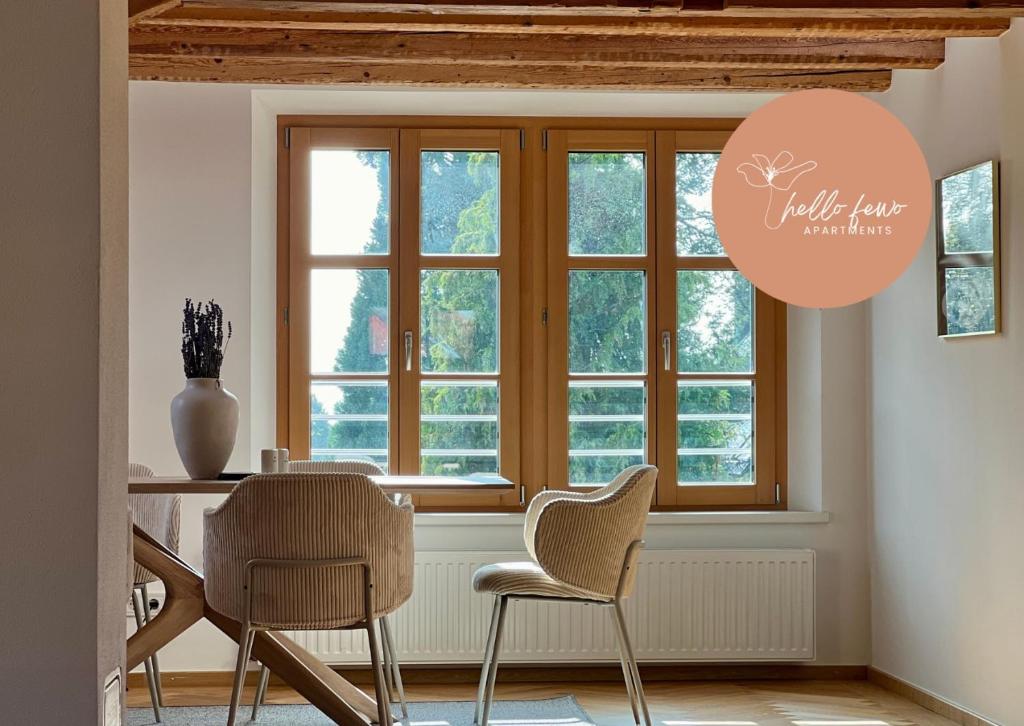 a dining room with a table and chairs and a window at Ferienzauber 1897 by Hello Fewo Apartments in Dornbirn