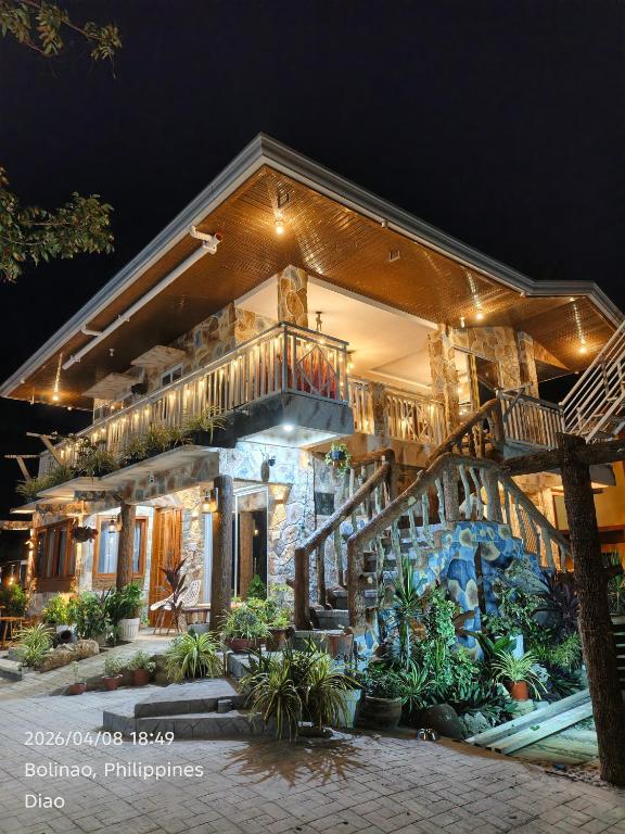 a house with a staircase in front of it at Ocean View and Beach Access Rustic Stone House in Bolinao