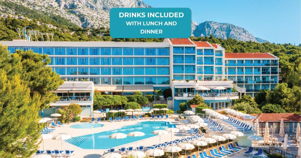 a view of a hotel with a pool and chairs at Aminess Vival Grand Azur Hotel in Orebić