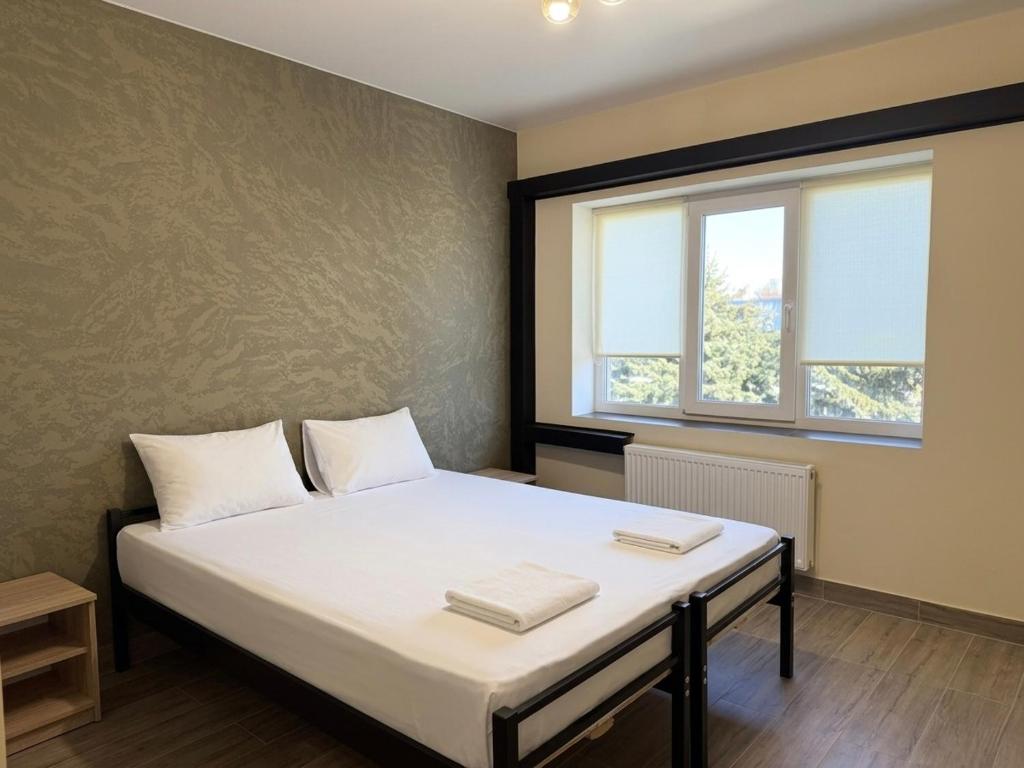 a bedroom with a bed with two pillows on it at Shpola Central Hotel in Shpola