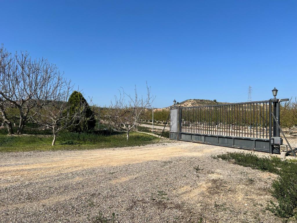 a fence on the side of a dirt road at Mas d'Arturo in Serós