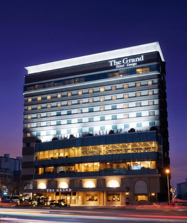 a large building with a sign on it at night at Daegu Grand Hotel in Daegu