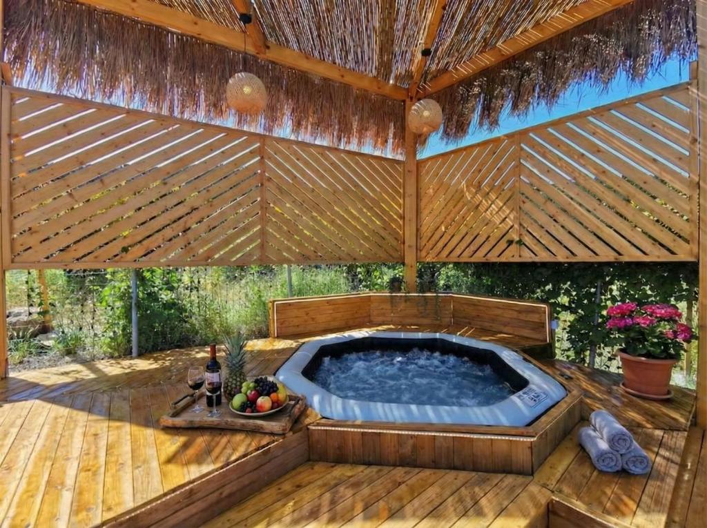 a hot tub in a patio with a roof at Elite Country House in Ialysos