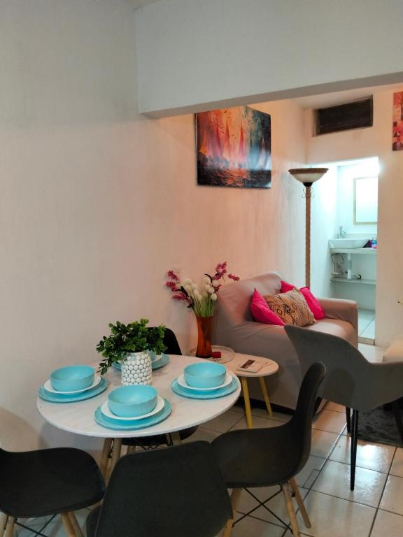 a living room with a table and a couch at departamento bugambilias in Tepic