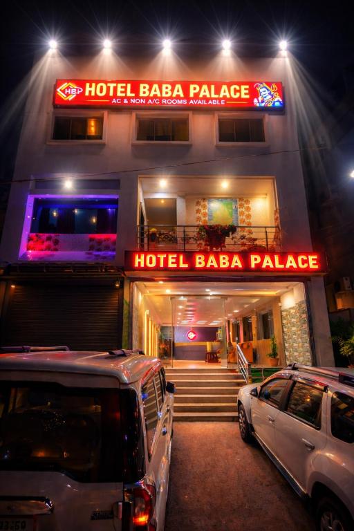 a hotel with two cars parked in front of it at Hotel Baba Palace in Deoghar