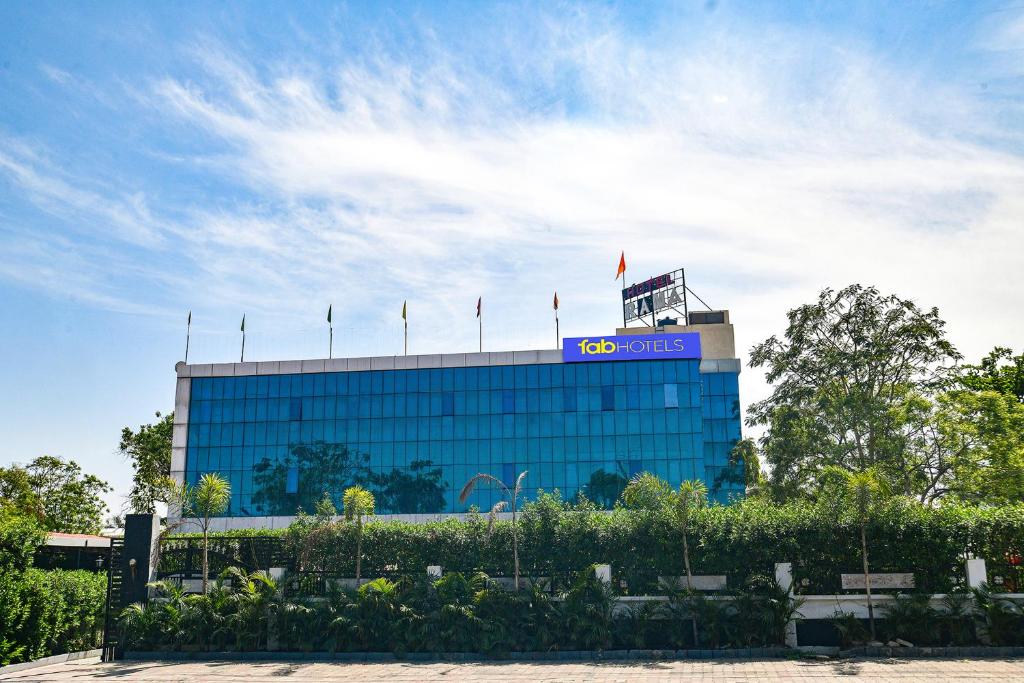 a blue building with a sign on top of it at FabHotel Rama in Indore