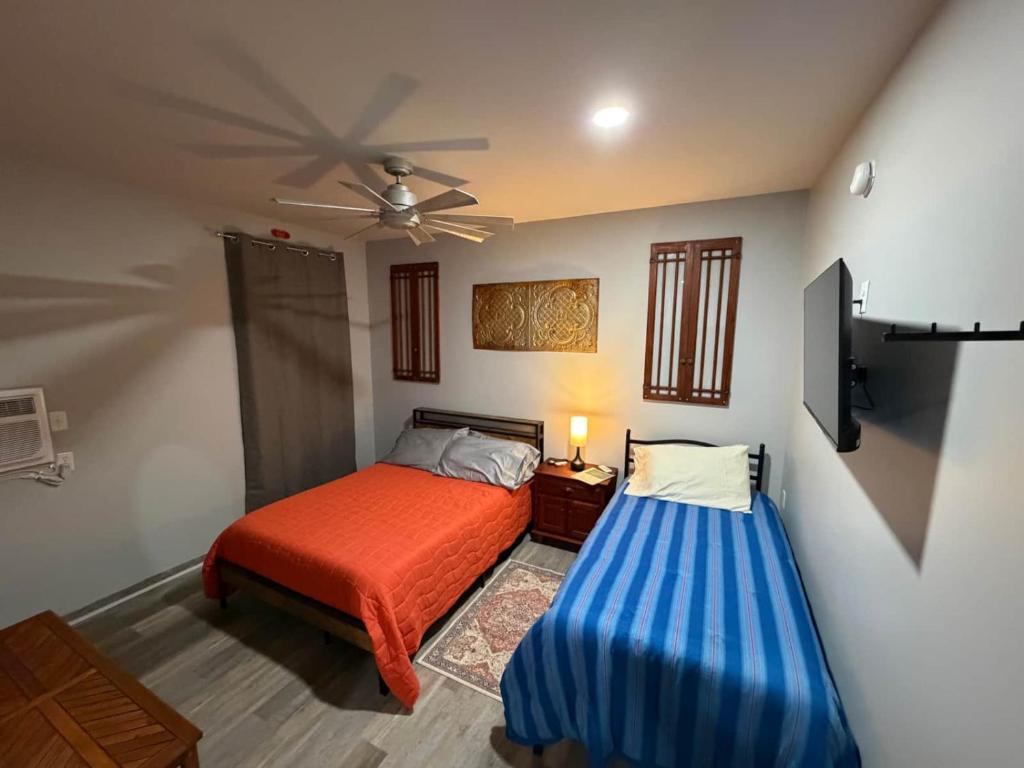a bedroom with a bed and a ceiling fan at Germantown Inn & Lounge in Hermann