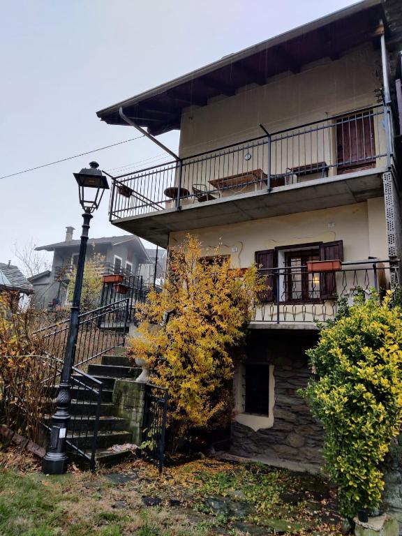 an apartment building with stairs and a street light at The Golden Eagle - Champdepraz in Champdepraz
