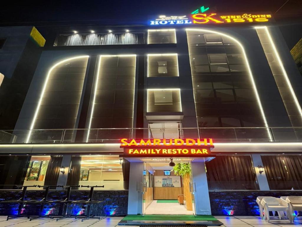 a hotel with a sign in front of a building at Hotel SK Chakan Pune in Dehu