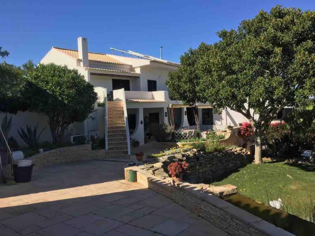 a large white house with a driveway at Great double bedroom in beautiful Quinta - QR07 in Lagos