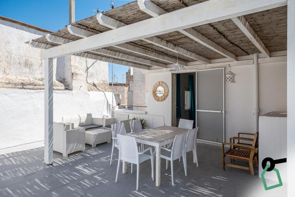 a dining area with a table and chairs on a patio at Hotiday Gallipoli Castello in Gallipoli