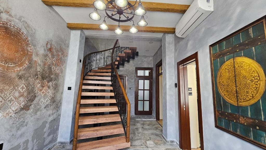 a stairway in a home with a chandelier at Konak 83 in Nicosia