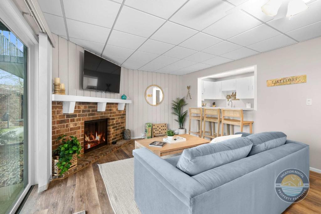 a living room with a couch and a fireplace at Lake Como Condo with Lake Views and Pool in Lake Geneva