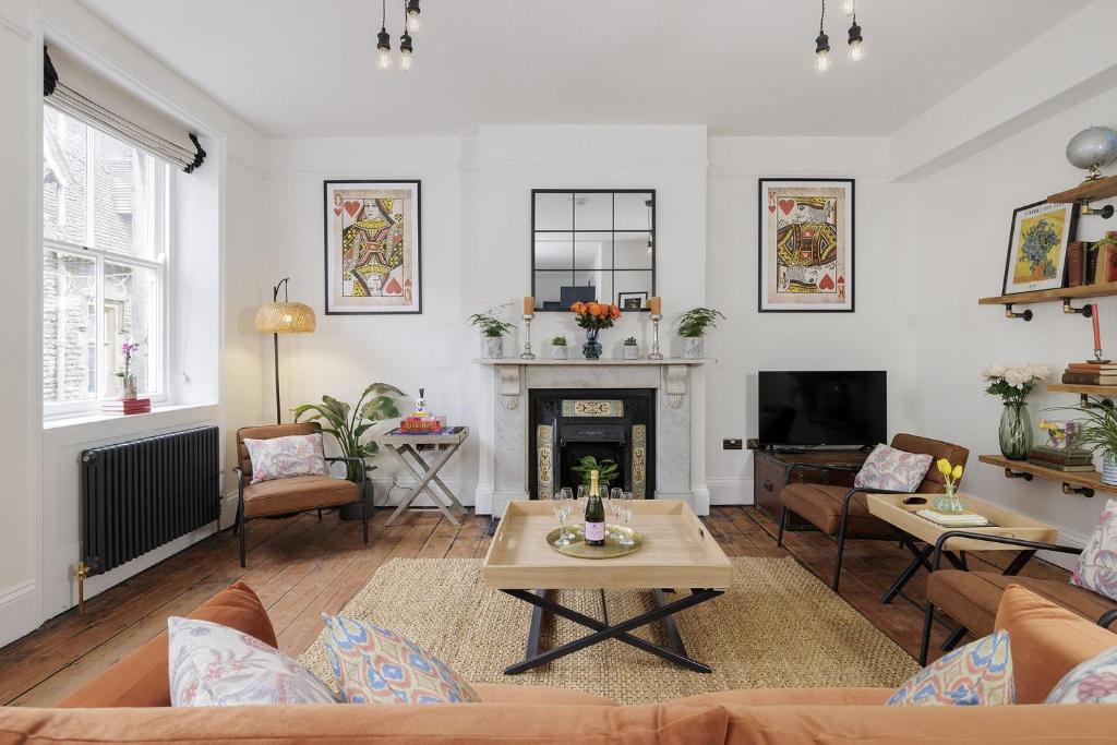 a living room with a couch and a fireplace at Bakers Flat in Cirencester