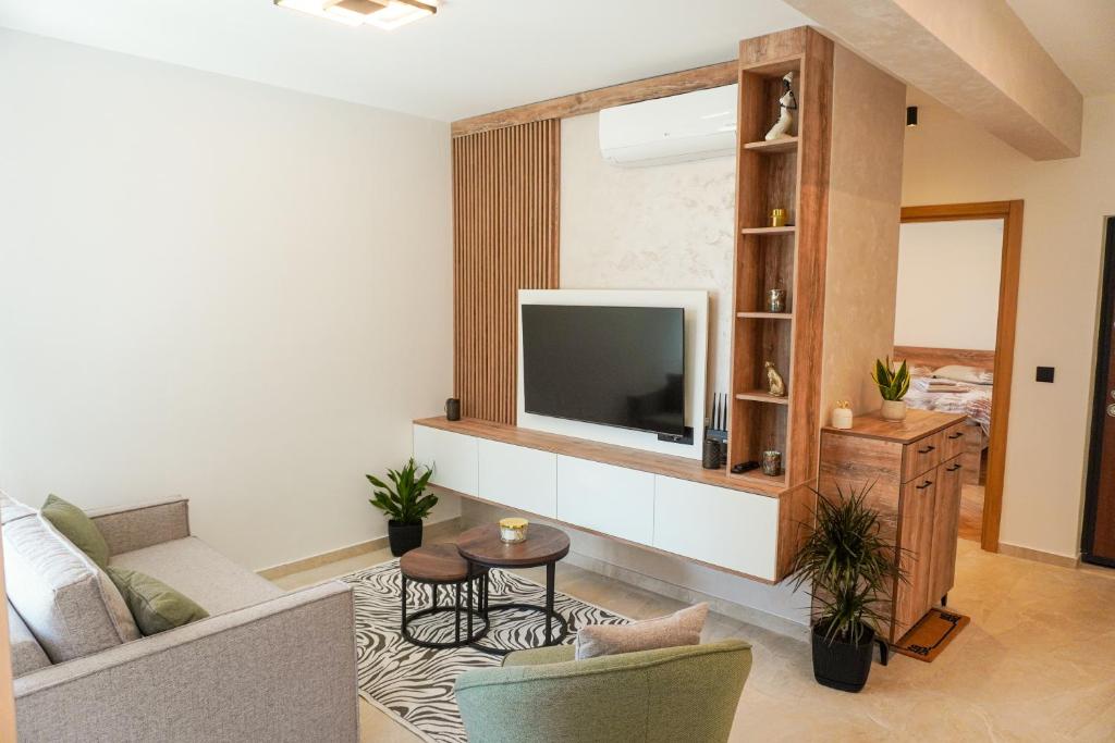 a living room with a couch and a tv at Casa Oliva Tivat in Tivat