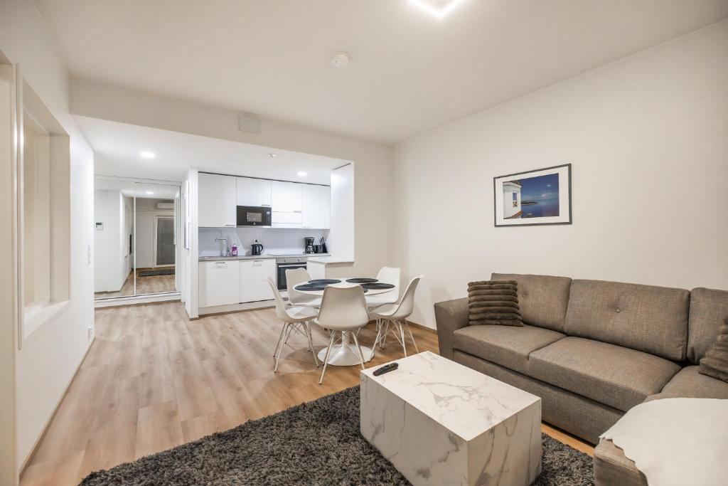a living room with a couch and a table at Lumi Apartments in Rovaniemi