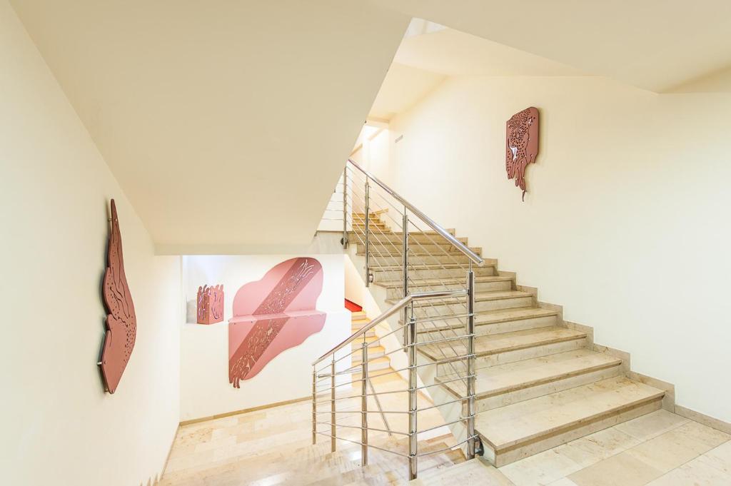 a staircase in a white room with a stair railing at Hotel Alexander in Krakow