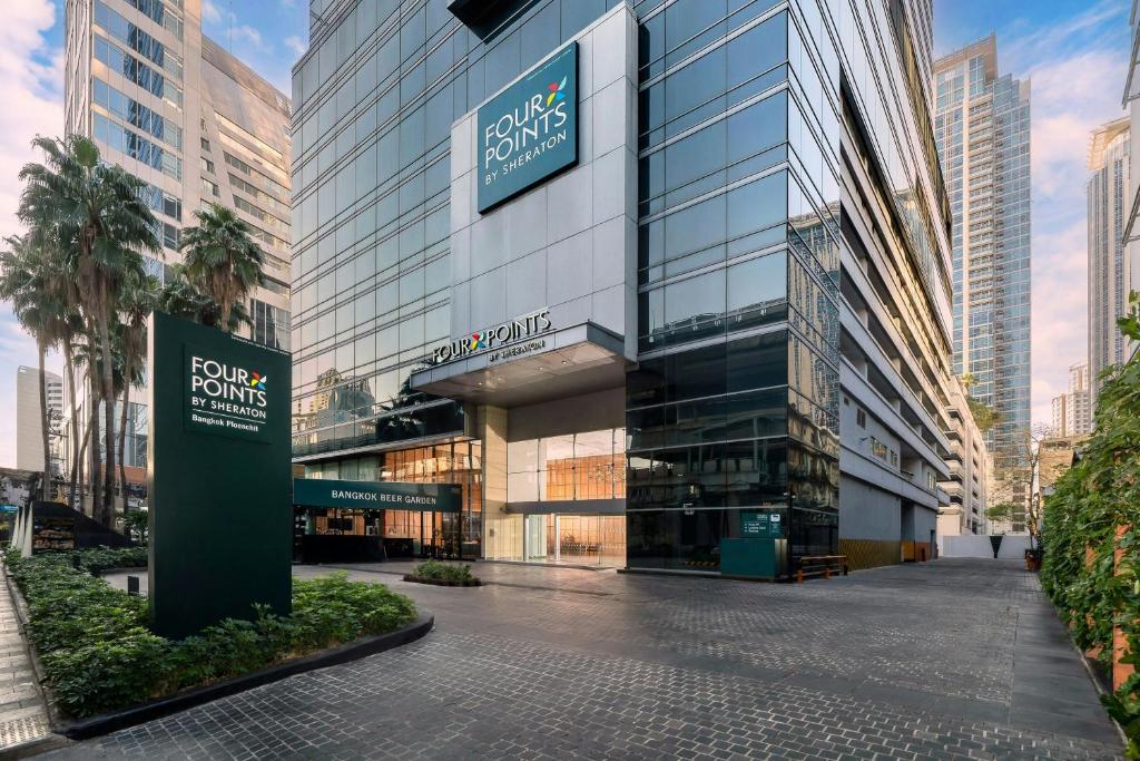 a building with a sign in front of it at Four Points by Sheraton Bangkok Ploenchit Sukhumvit in Bangkok