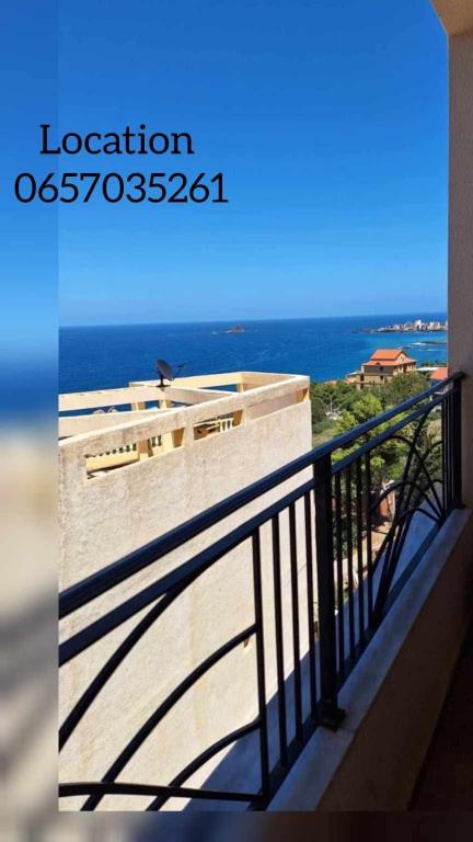 a balcony with a view of the ocean at Maya location in Bejaïa