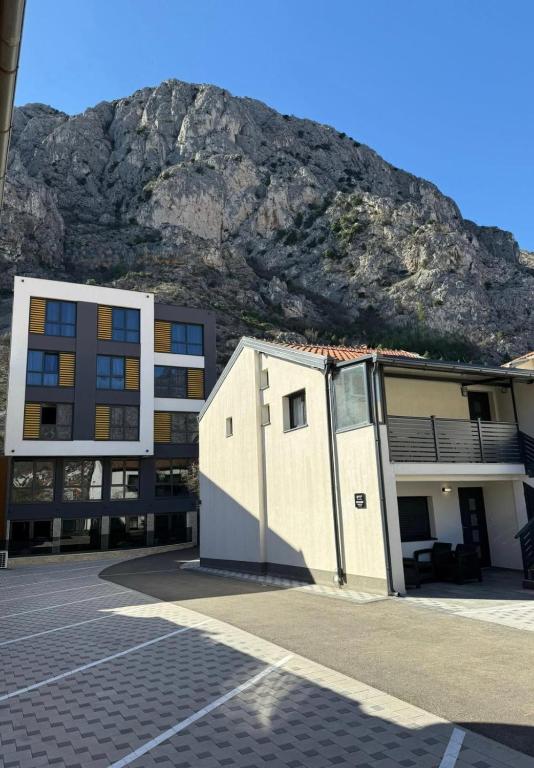 a building with a mountain in the background at Olive Depadance in Mostar