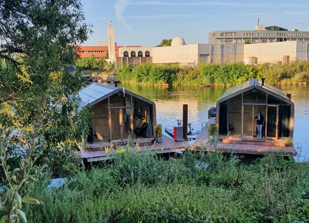 two boats are docked on a dock in the water at Wikkelboats at Tramkade Den Bosch in Orthen