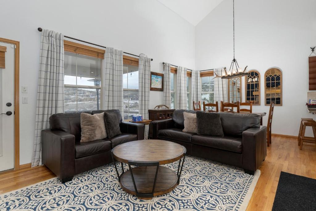 a living room with two couches and a table at 100 Fairway Lane in Granby