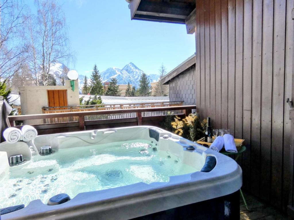 a jacuzzi tub in the backyard of a house at Appartement 3 chambres - 100m2 - Jacuzzi in Les Deux Alpes