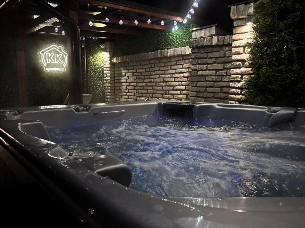 a jacuzzi tub in a backyard at night at KK Apartment in Bačka Topola