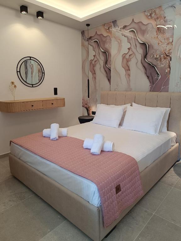 a bedroom with a large bed with white pillows at Th Tsimas Luxury studio 4 in Skala Potamias