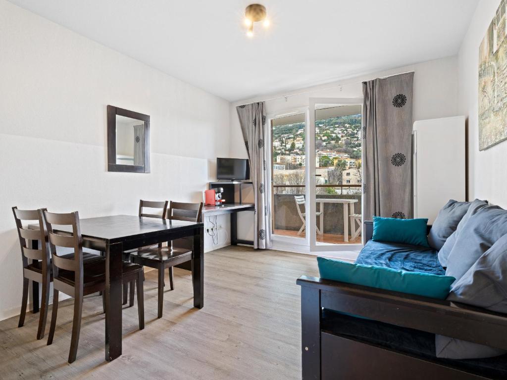 a living room with a table and a dining room at Virginia N213 - 2p4 in Grasse