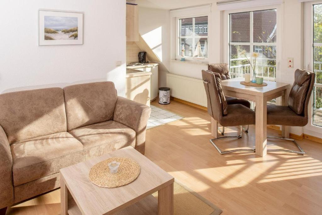 a living room with a couch and a table at Ayuna in Langeoog