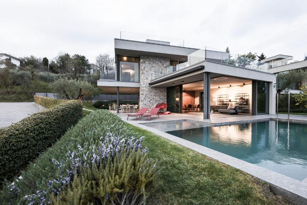 a house with a swimming pool in front of it at Villa La Biancolilla in Garda