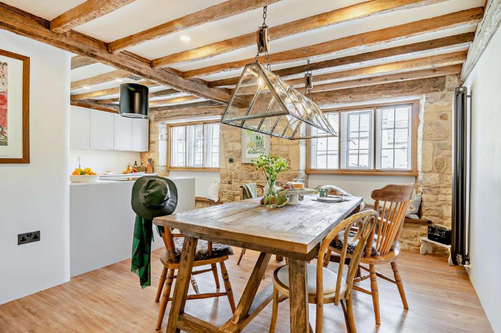 a kitchen and dining room with a wooden table and chairs at Butchers Flat in Chipping Campden