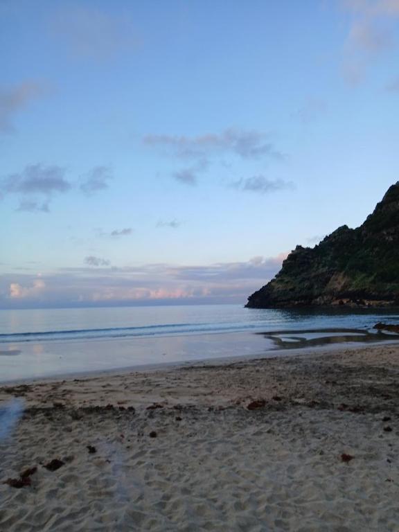 a sandy beach with the ocean in the background at Casa dos Magalhães in Vila do Porto
