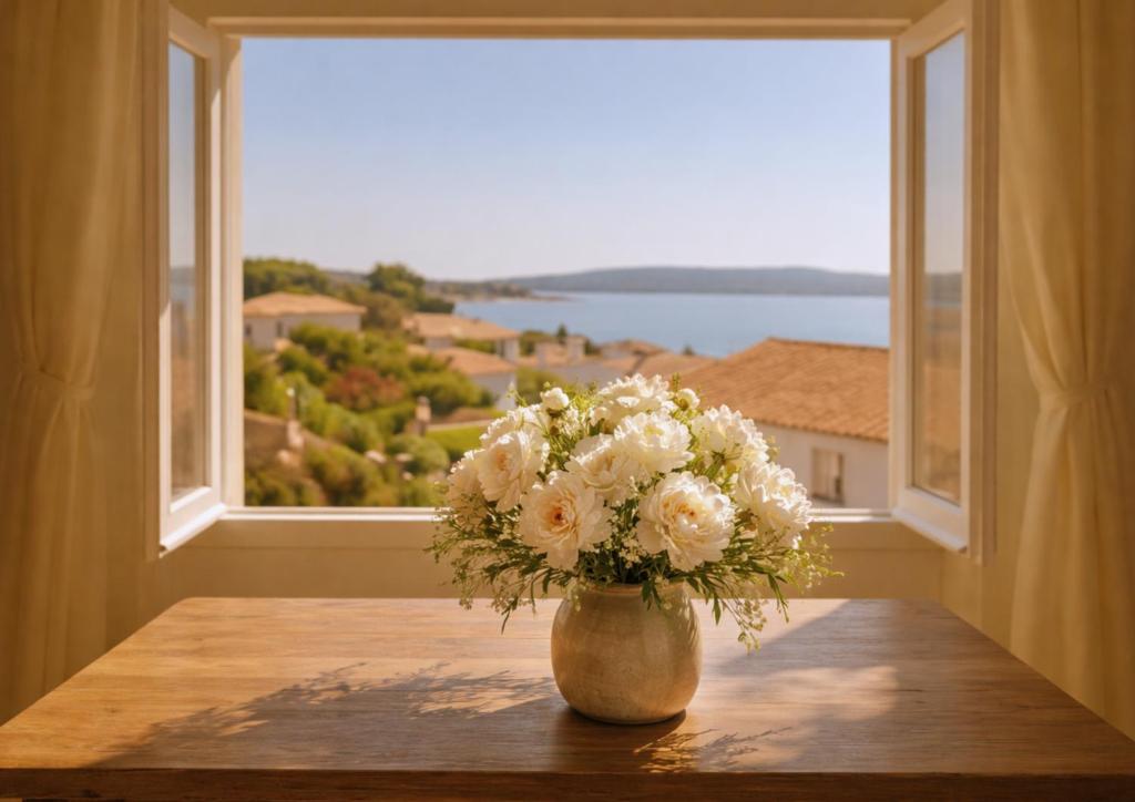 a vase of flowers sitting on a table in front of a window at Maison de Thau in Mèze