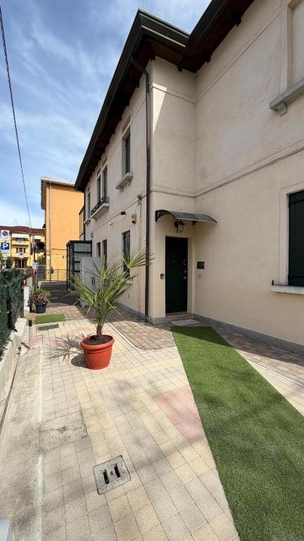 a large white building with a potted plant in a yard at My Tiny Home Venice in Marghera