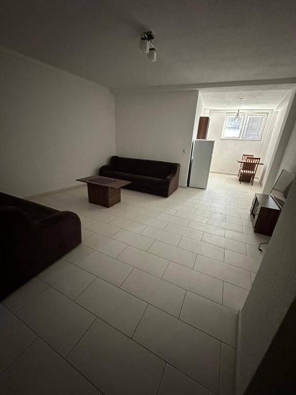 a living room with a couch and a table at Salihu in Ferizaj