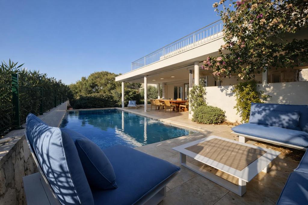 a backyard with a swimming pool and a house at Villa GIUSEPPE in Potocnica
