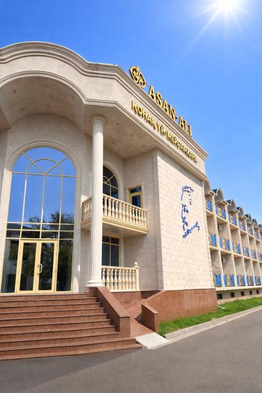 a white building with stairs in front of it at Гостиница Asan Ali in Kapchagay