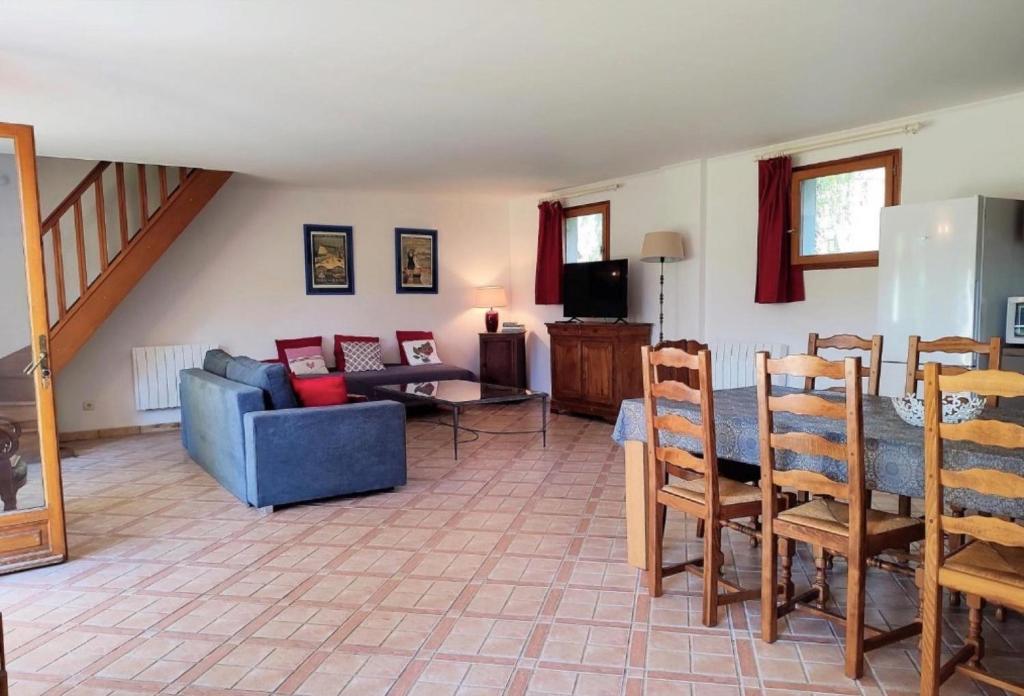 a living room with a couch and a table at Gîte Le Clos aux Cerises in Eu