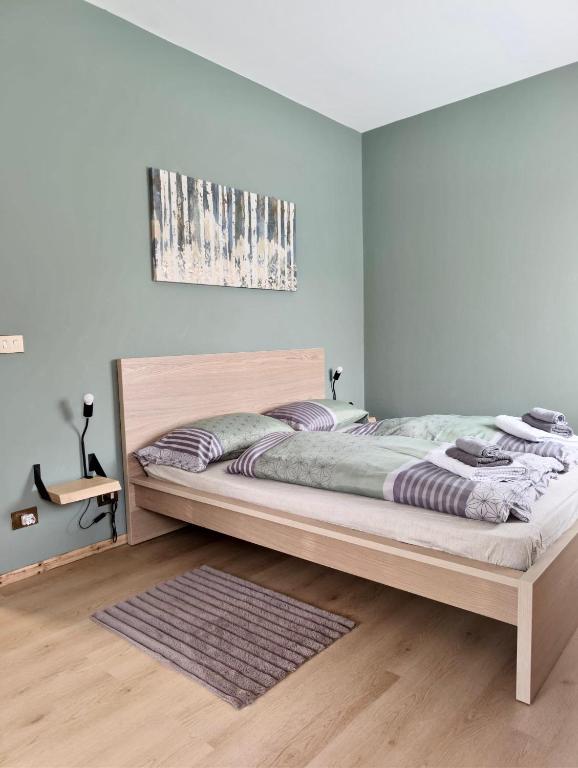 a bedroom with a large bed in a room at Bosco Verde in Tarvisio