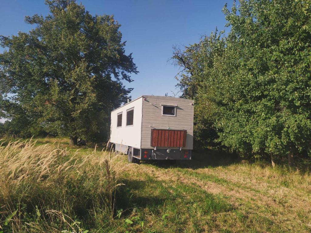 a tiny house sitting on a hill in a field at Mája u lomu in Stachlovice
