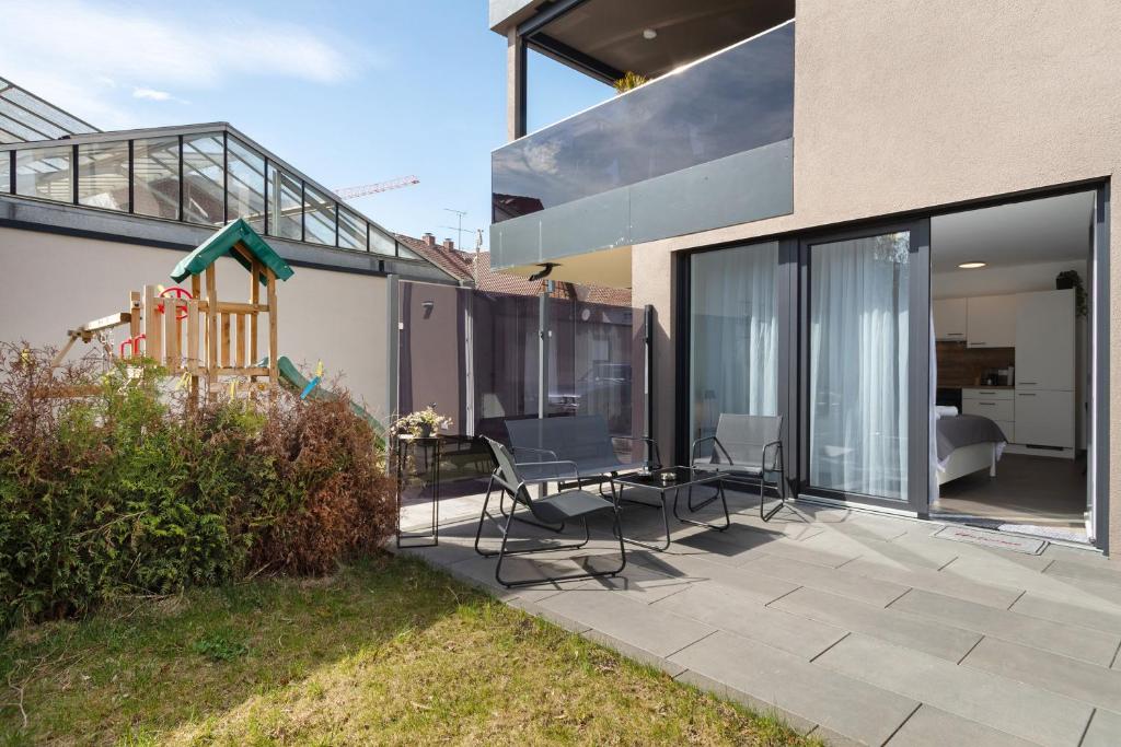 a patio with chairs and a table on a house at Apartment Aura in Mengen