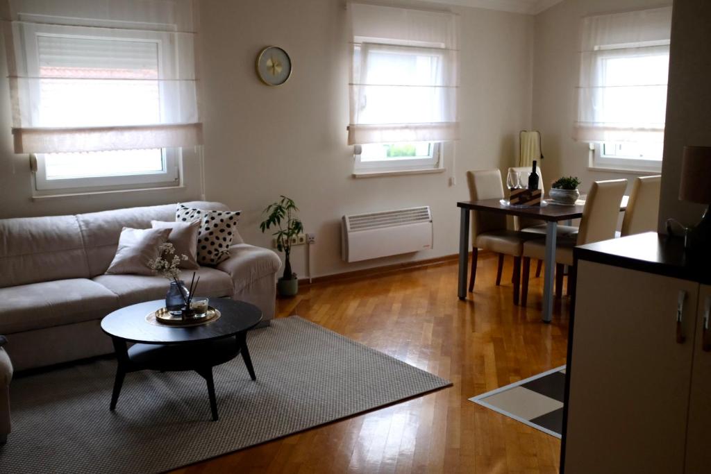 a living room with a couch and a table at Apartman Spanish Square in Mostar