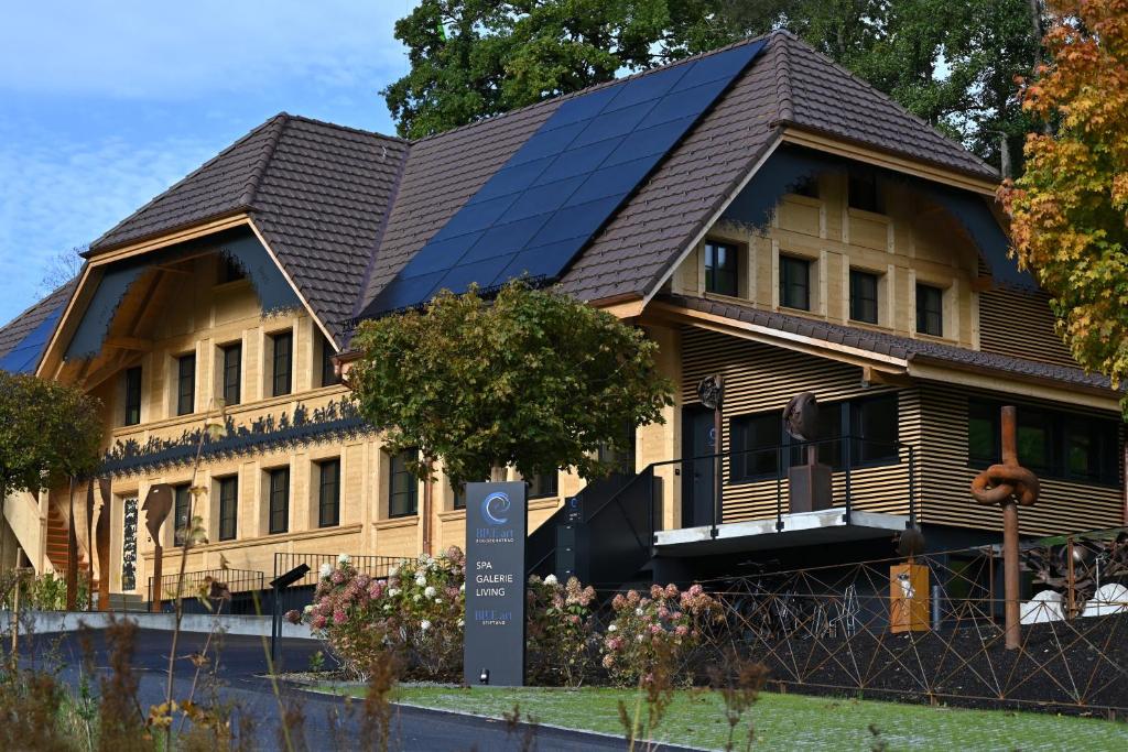 a house with solar panels on the side of it at BLUE-art Ferienwohnung in Wyssachen